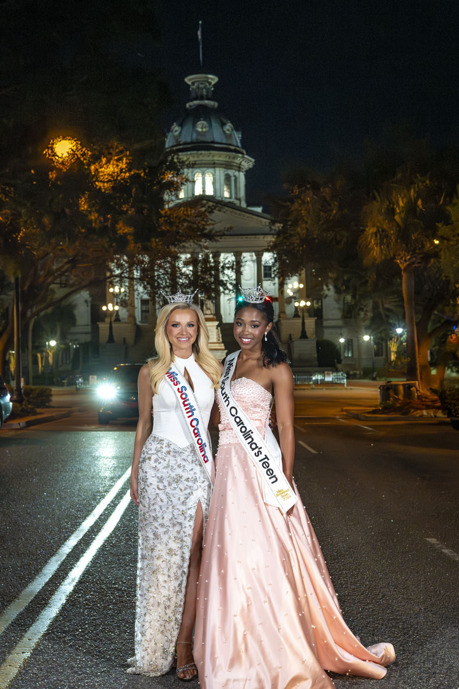 Two titleholders photographed outside the South Carolina statehouse at night
